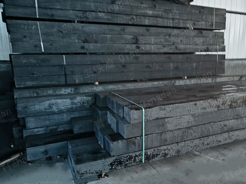 Why do you need to pave gravel under wooden sleepers? The black wood and stones match well